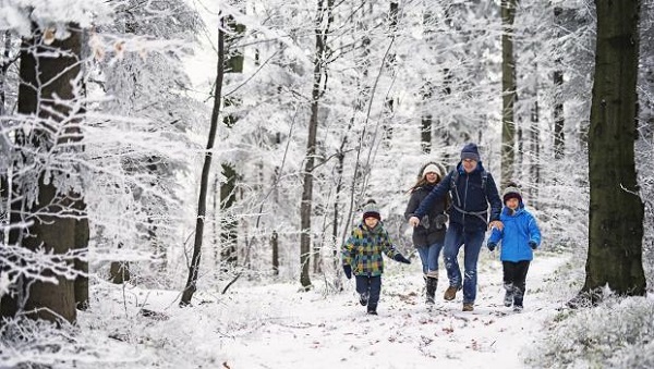 Téli erdőben kiránduló család